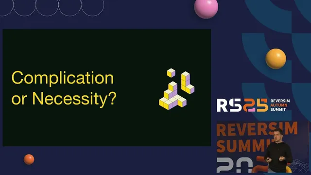 Frame from the recording: a slide reading “Complication or Necessity?” beside the Reversim Autumn Summit logo, with Jeb on stage in the corner
